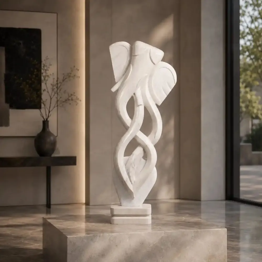 Abstract white marble sculpture on a stone plinth beside a window